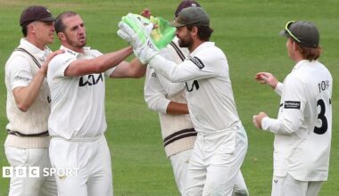 Surrey players celebrate taking a wicket