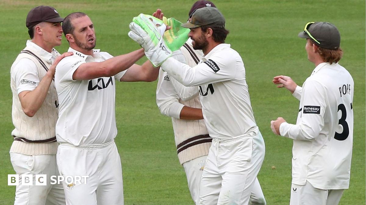 Surrey players celebrate taking a wicket