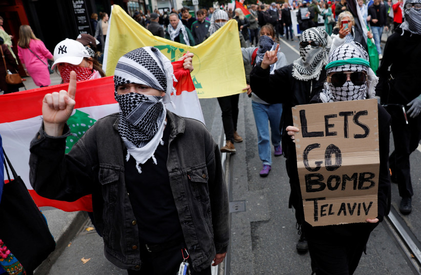 People hold placards and flags during a demonstration in solidarity with Palestinians in Gaza, ahead of the October 7 attack anniversary, amid the Israel-Hamas conflict, in Dublin, Ireland October 5, 2024.