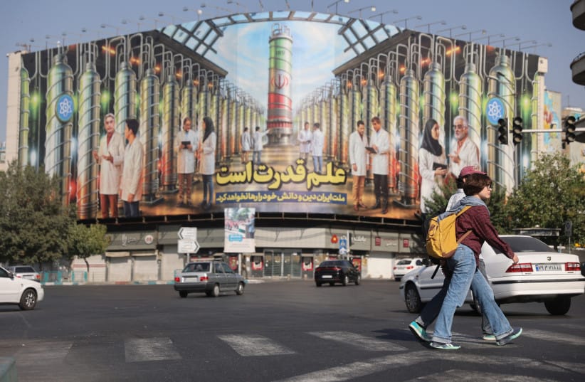 A billboard with Iranian centrifuges illustrations and portraits of nuclear scientists killed in Israeli strikes is displayed on a street in Tehran, Iran August 29, 2025 (credit: MAJID ASGARIPOUR/WANA