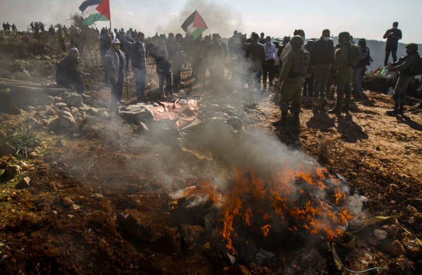 Israeli settlers clash with Palestinians protestor during a protest against Israeli settlements, near the West Bank city of Salfit, November 30, 2020.