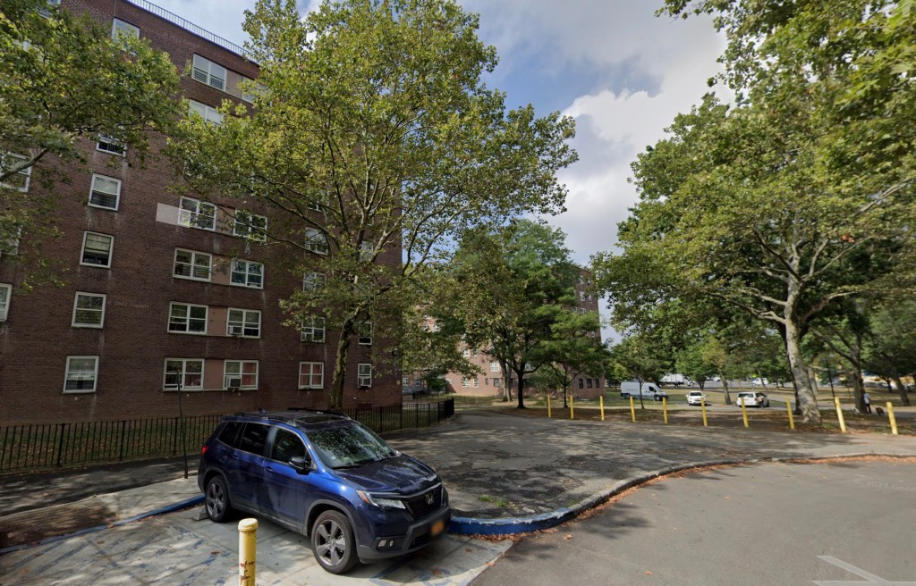 A blue SUV parked in front of a brick building at 700 Euclid Ave, Brooklyn, NY 11208.