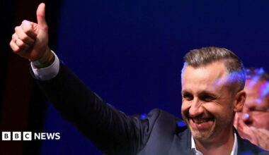 Ulrich Siegmund, leader of the AfD in the state, raises a thumbs up at the election party.