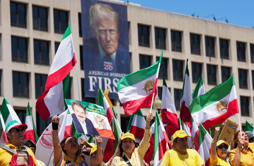 Iranian Americans and supporters of the National Council of Resistance of Iran take part in a march passing in front of the US Department of Labor building with a banner with the image of US President Donald Trump, in Washington, DC, US, May 16, 2026.