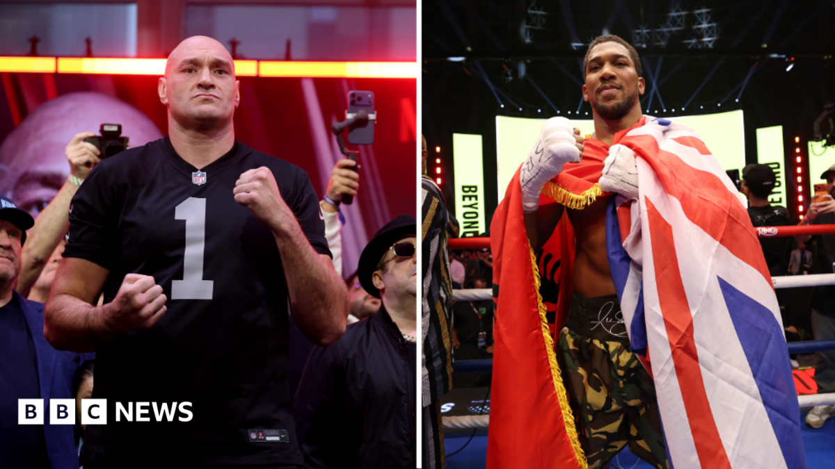 Side by side images of Tyson Fury and Anthony Joshua. Fury has a black NFL top with the number one on it. Joshua is wrapped in a Union Jack flag with khaki shorts on.