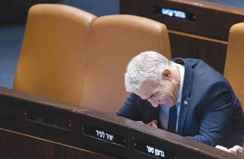 MK YAIR LAPID enjoys a laugh in the Knesset.