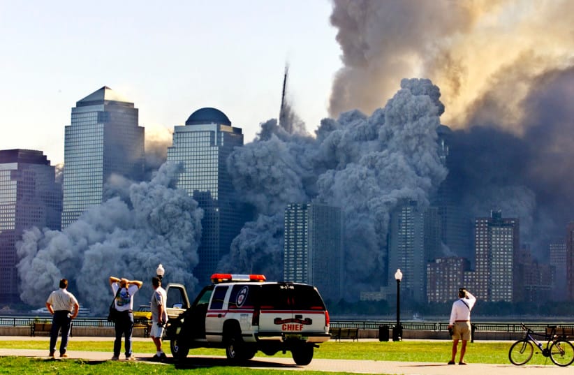 The remaining tower of New York's World Trade Center, Tower 2, dissolves in a cloud of dust and debris about a half hour after the first twin tower collapsed September 11, 2001.