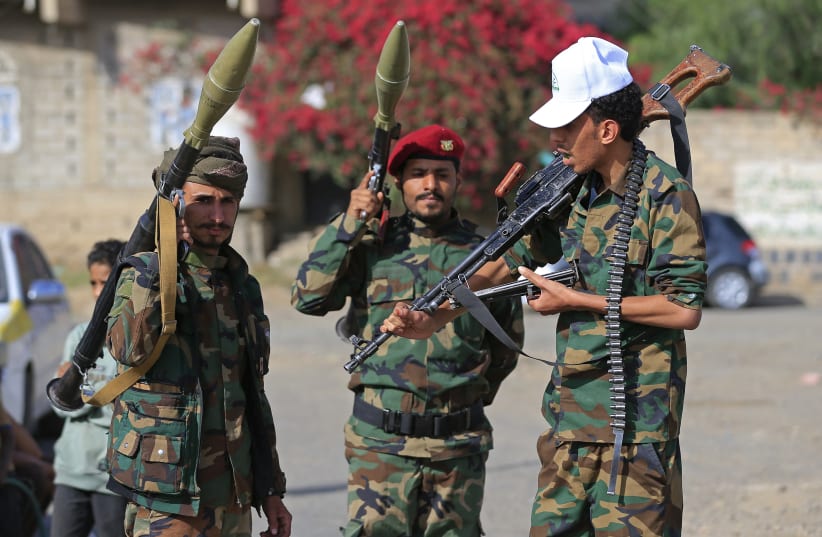 Fighters loyal to the Houthi authorities, brandish their weapons during a rally to recruit more fighters, in Sanaa on September 10, 2026.