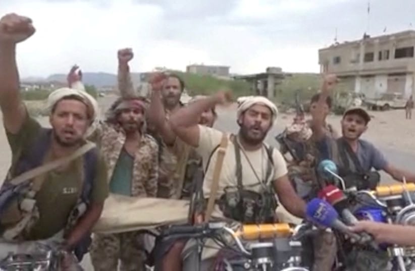 Men gesture in a screen grab from a video released September 11, 2026 and said to show Khaled bin Walid camp after Houthis captured the city of Mocha in Taiz Province.