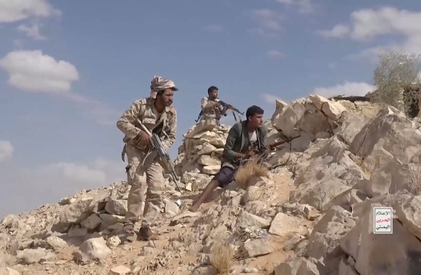 Iran-aligned Houthi fighters occupy a firing position in a screengrab from a video said to show Houthi fighters attacking Saudi-backed forces in the location given by the source as al Jawf governorate, Yemen.