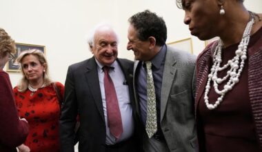 US Rep. Sandy Levin (D-MI) (2nd L) shares a moment with his son Rep.-elect Andy Levin (D-MI) (3rd L), who will succeed him in the 116th Congress, as Rep. Debbie Dingell (D-MI) (L), and Rep. Brenda Lawrence (D-MI) (R) look on after a news conference on auto jobs November 29, 2018; illustrative