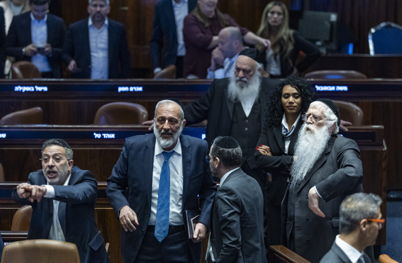 Shas chairman Aryeh Deri, government ministers and members of Knesset attend a plenum session and a vote on a bill to freeze arrests of haredi draft evaders at the assembly hall of the Knesset, the Israeli parliament in Jerusalem, July 14, 2026.