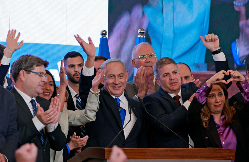 Prime Minister Benjamin Netanyahu, flanked by members of his Likud party, addresses supporters at campaign headquarters in Jerusalem during the 2022 election.