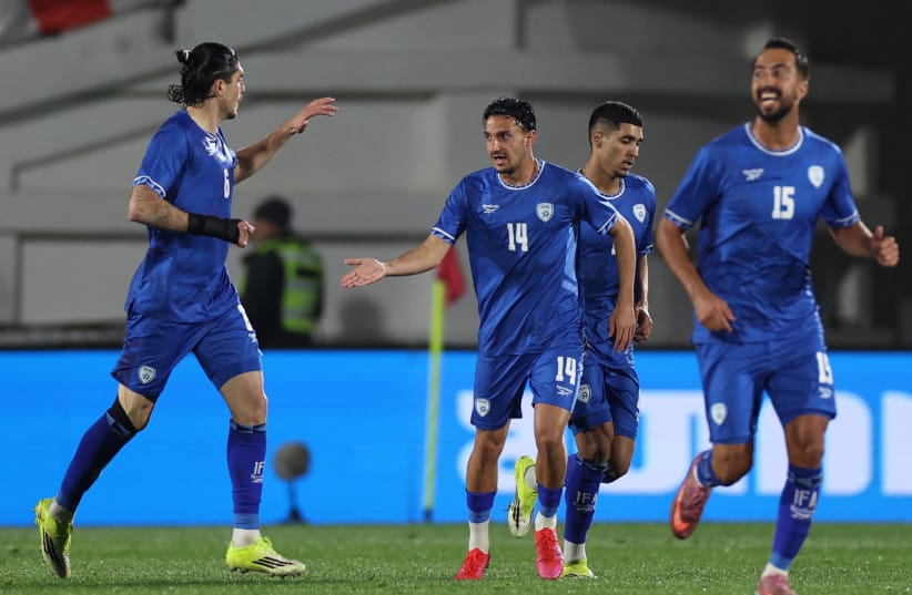 Israel's midfielder Guy Mizrahi celebrates with teammates after scoring the team's first goal during the friendly football match between Georgia and Israel in Tbilisi on March 26, 2026.