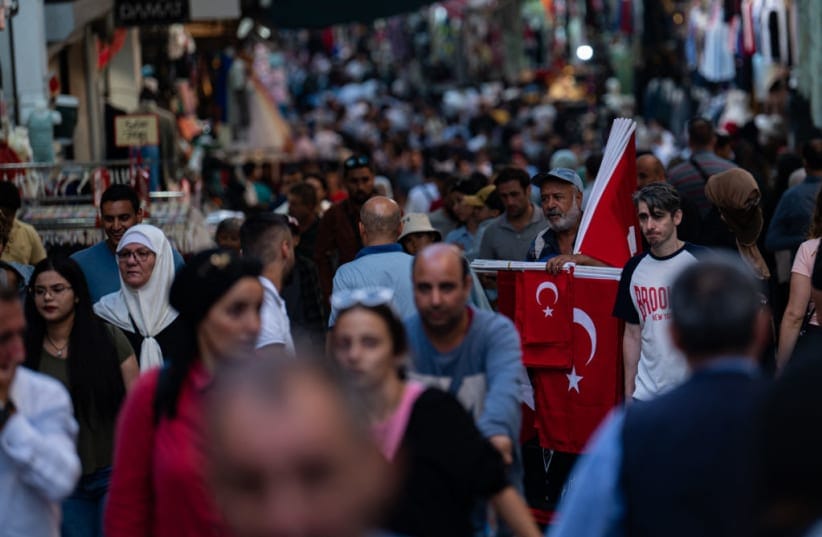 Illustrative: Customers walk past a flag vendor as they shop at a bazaar in Istanbul on September 6, 2022. 