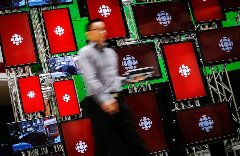 A man walks inside the Canadian Broadcast Corporation (CBC) broadcasting centre in Toronto Friday, 23rd May 2014