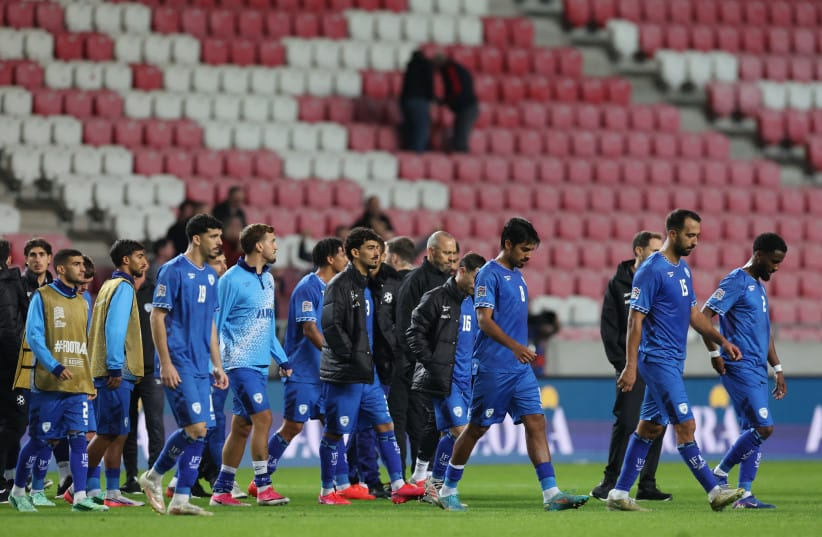 Israel's Dor Peretz with teammates look dejected after the match.