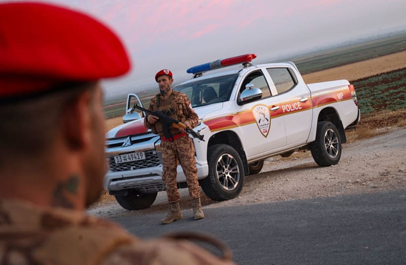 Military personnel stand guard near the site of explosions at an army weapons depot in the Al-Hadaba area near Aleppo, Syria, on September 21, 2026.