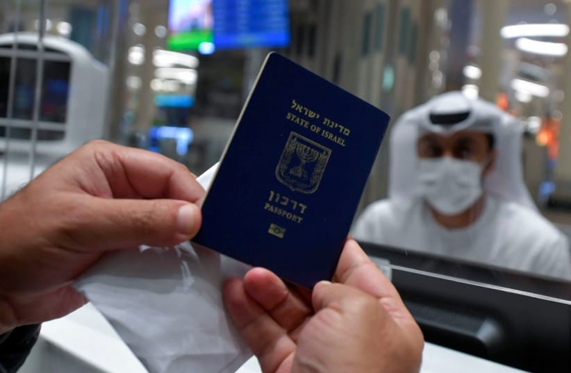 An Israeli man presents his passport for control upon arrival from Tel Aviv to the Dubai airport in the United Arab Emirates, on November 26, 2020, on the first scheduled commercial flight operated by budget airline flydubai, following the normalisation of ties between the UAE and Israel.