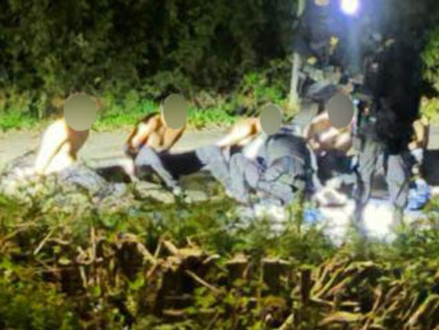 A photo geolocated by CNN shows suspects arrested and on the ground in Fairford on Sunday.