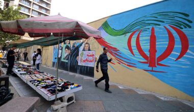 A pedestrian walks past a wall mural along a street in downtown of Tehran on Aug. 31, 2026. Iran attacked US military targets in the Middle East on Aug. 31 in retaliation for American strikes on an island in the Strait of Hormuz, the first exchange of fire for a month in a war that has engulfed the region. Six months into the conflict, the two sides remain at an impasse, with Iran keeping the strategic strait shut and Washington persisting with a naval counter-blockade of Iran.
