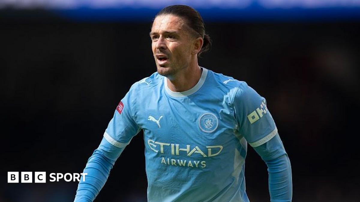 Jack Grealish wearing a blue Manchester City shirt