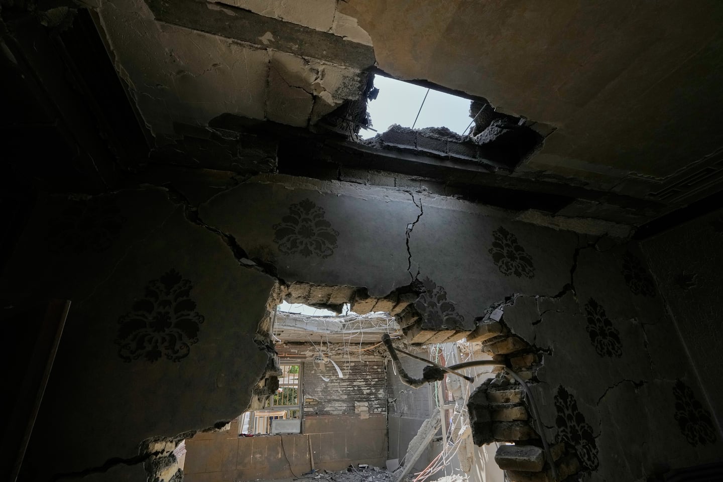 A hole in the ceiling and damaged walls are seen inside a home that Iranian media said was hit by a US strike while a wedding celebration was taking place on Sept. 1, in Kuhestak, southern Iran, on Sept. 4, 2026.