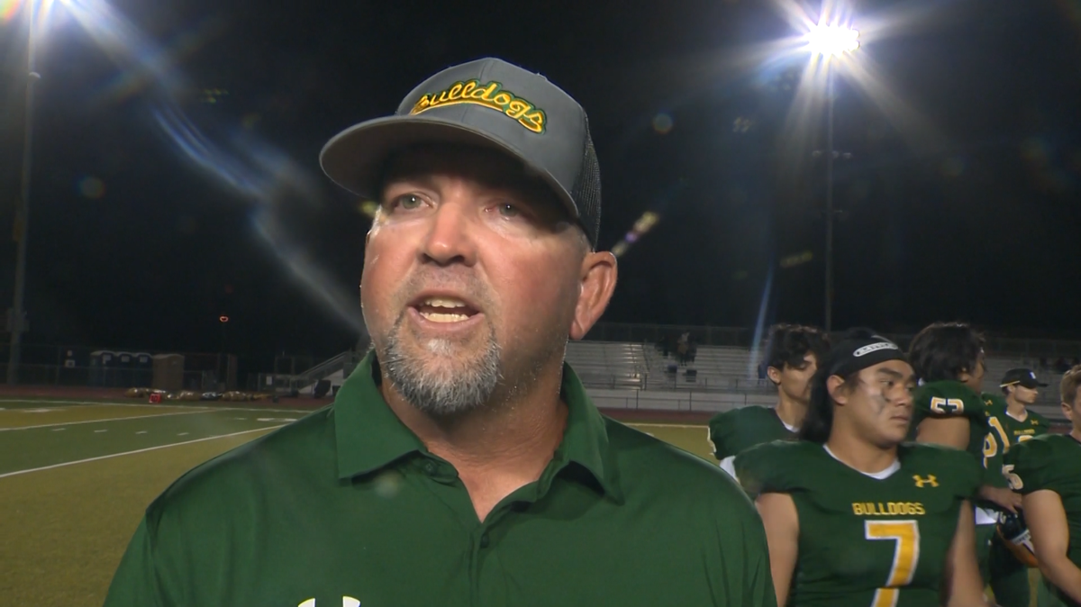 Football coach arrested after phone found recording students, police say