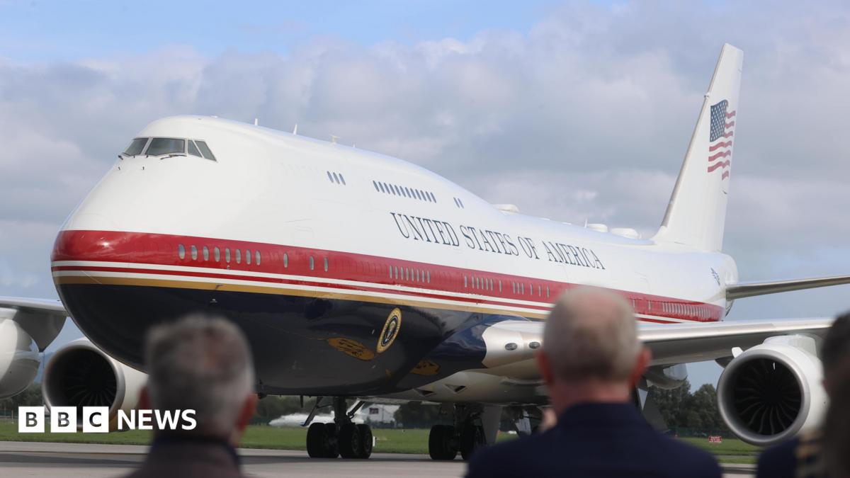 Air Force One on the tarmac in Ireland with blurred out people watching on.