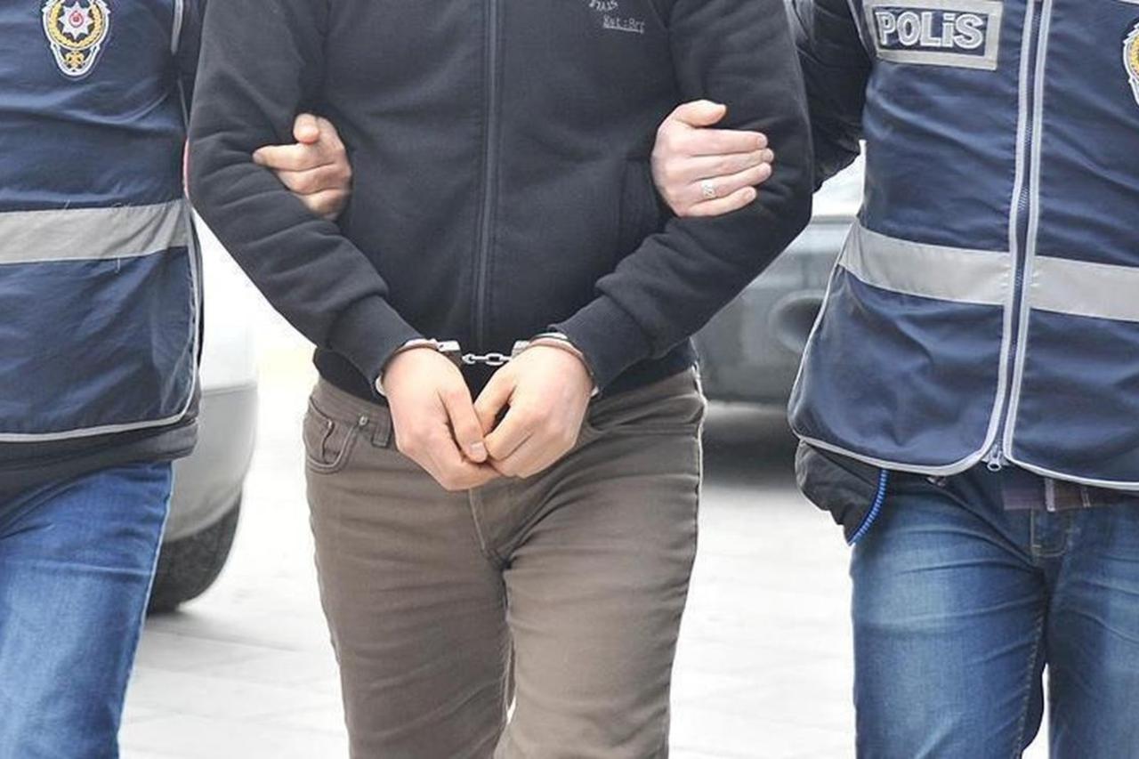 A handcuffed person being escorted by two Turkish police officers somewhere in Türkiye on an unknown date. (AA Photo)