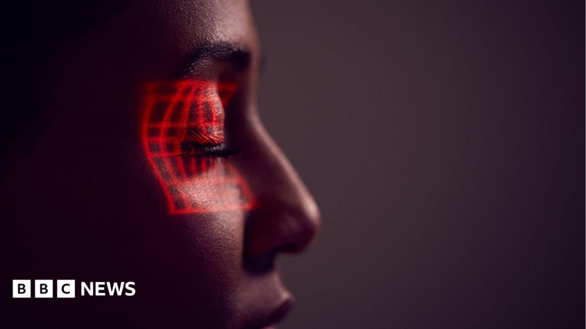 Facial Recognition Technology Concept As Woman Has Red Grid Projected Onto Eye In Studio