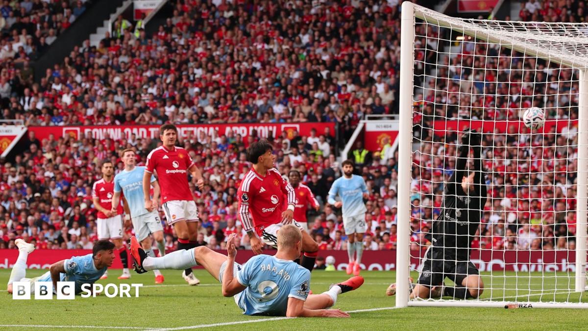 Manchester City striker Erling Haaland scores for his side as team-mate Enzo Fernandez watches on after failing to make contact with a diving header