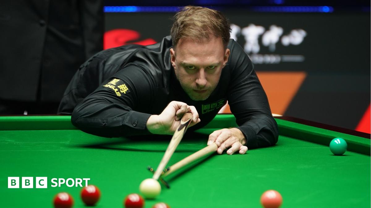 Judd Trump plays a shot with the rest