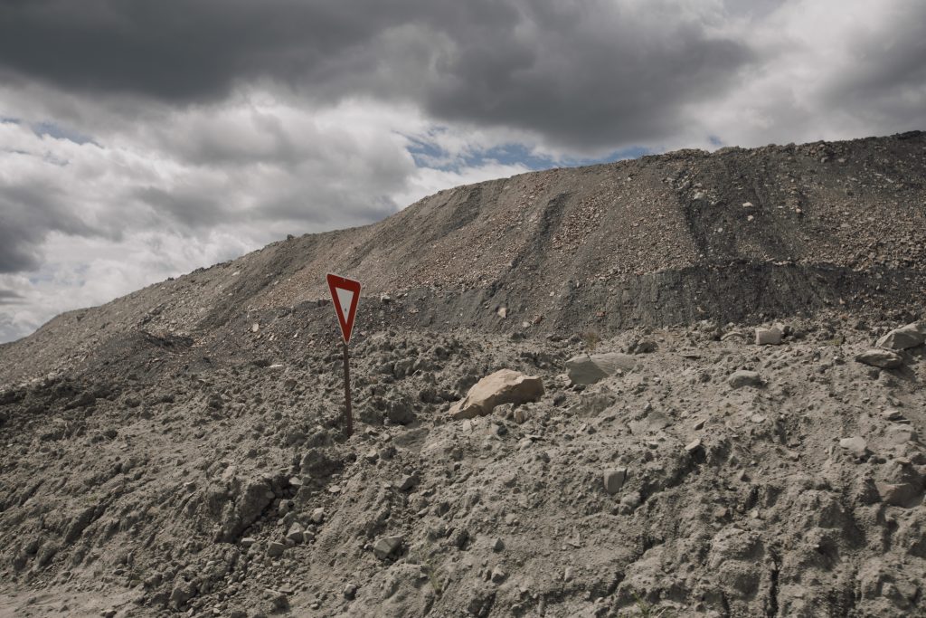 A yield sign sticks out of a pile of excess rock and dirt at the Coal Valley mine south of Edson, Alberta.