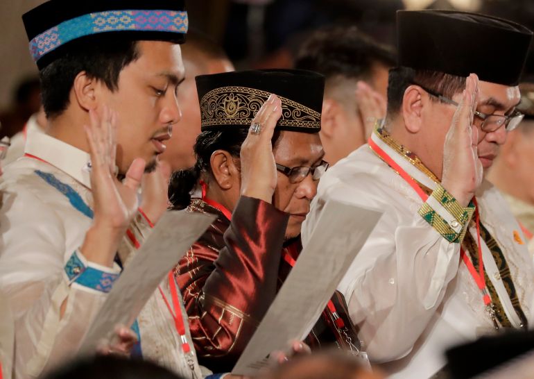 Abdullah Macapaar, centre, along with some of the fiercest Muslim rebel commanders in the southern Philippines, takes his oath during a ceremony for the creation of the Bangsamoro Transition Authority (BTA) at the Presidential Palace in Manila, Philippines, on February 22, 2019