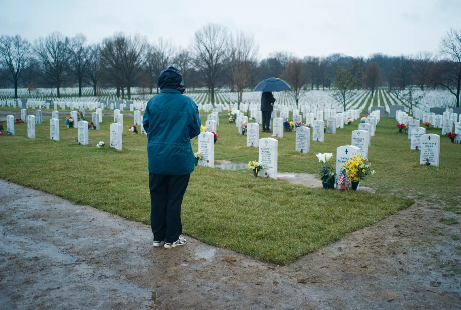 The parents of U.S. Army Pfc. David H. Sharrett II spend time at his grave in Section 60, where many military personnel killed in Iraq and Afghanistan are buried, at Arlington National Cemetery, Arlington, Virginia.