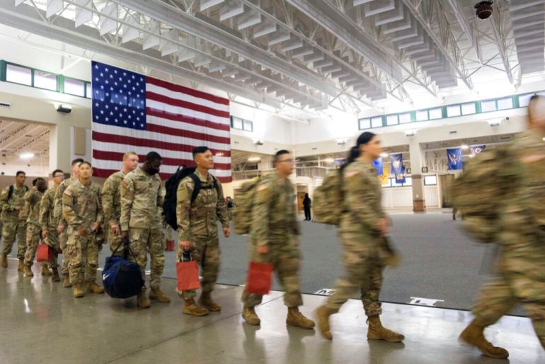 About 130 soldiers with the US Army’s 87th Division Sustainment Support Battalion, 3rd Division Sustainment Brigade, wait to board a chartered plane during their deployment to Europe, March 11, 2022, at Hunter Army Airfield in Savannah, Georgia, US