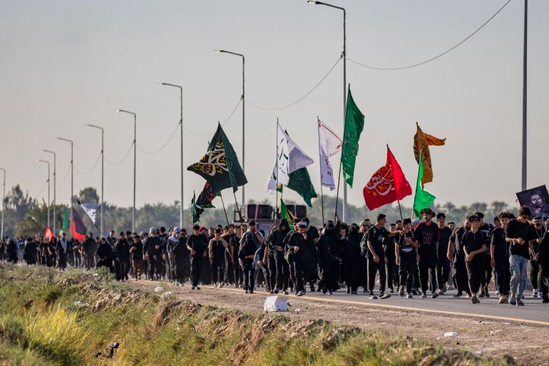 Shiite pilgrims march to Karbala, to observe Arbaeen that marks the end of a 40-day mourning period following the Day of Ashura, in Najaf, Iraq [Anmar Khalil/AP]