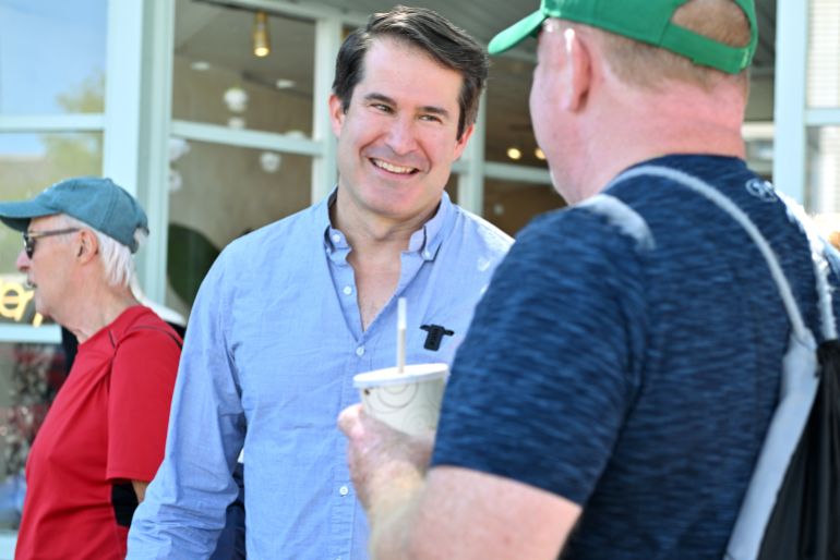 U.S. Rep. Seth Moulton, D-Mass. who is campaigning to unseat Sen. Ed Markey, D-Mass., speaks to prospective voters Saturday, Aug. 29, 2026, in Wakefield, Mass. (AP Photo/Josh Reynolds)