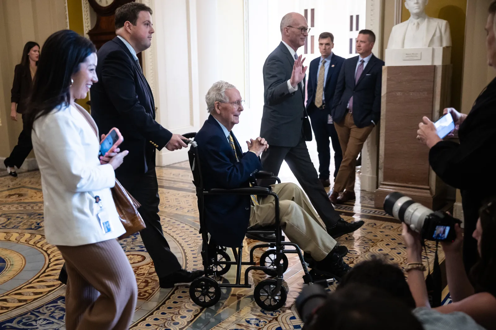 McConnell is wheeled away after speaking with reporters as he arrives for a vote at the U.S. Capitol on September 14. (Francis Chung/POLITICO via AP Images)