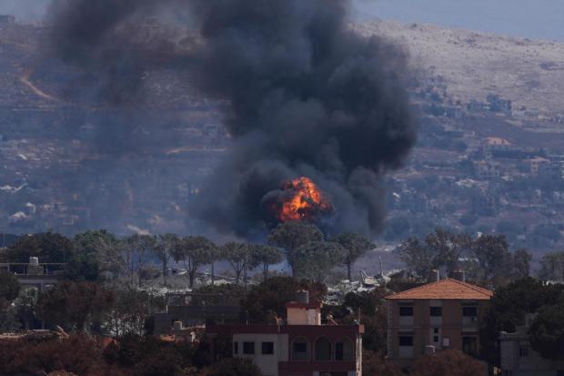 Smoke and flames rise as Israeli forces demolish homes in Zawtar al-Sharqiyah.