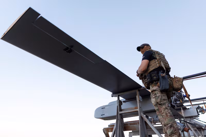 A service member of the 414th Separate Unmanned Strike Aviation System Brigade 'Magyar's Birds' of the Ukrainian Armed Forces stands next to FP-1 deep-strike drones before their launch for a combat mission, amid Russia's attack on Ukraine, in an undisclosed location in Ukraine, in 2026. REUTERS/Valentyn Ogirenko