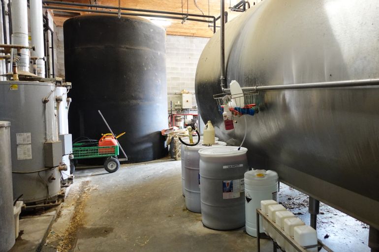 Each day almost 14,000 litres of milk produced by cows is stored in the refrigeration unit at Casey Pruim's Prime Acres Ltd. dairy farm in Abbotsford, British Columbia at a temperature of 2.8'C [Ali Mustafa/Al Jazeera]