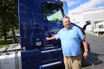 David Chalmers, the CEO of Bridgetown Trucking, stands with one of his company trucks in Portland, Ore., on Aug. 28 2026. Chalmers expects congestion to rank at seven on a scale of one to 10 when I-5 southbound closes. 