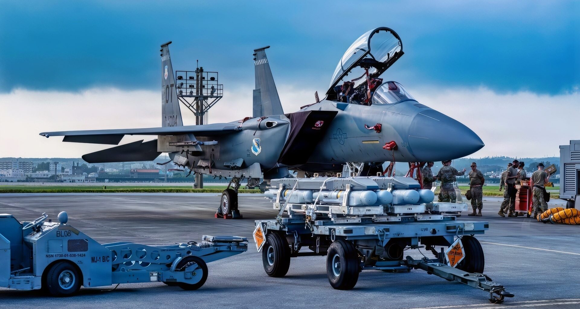 U.S. Air Force Airmen assigned to the 67th Fighter Generation Squadron prepare to load munitions onto a U.S. Air Force F-15EX Eagle II assigned to the 85th Test and Evaluation Squadron, Eglin Air Force Base, Florida, at Kadena Air Base, Japan, July 8, 2026. Airmen from the 67th Fighter Generation Squadron trained alongside the 85th TES gaining hands-on experience loading munitions on the F-15EX Eagle II and F-15E Strike Eagle while supporting test and evaluation operations. (U.S. Air Force photo by Airman 1st Class Gracelyn Hess)