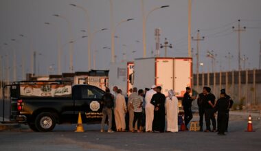 Stranded Iranians and Iraqis waited at the Iraq-Iran border following the Iraqi government's decision to close the Shalamsheh border crossing in the southern Basra province on Saturday.