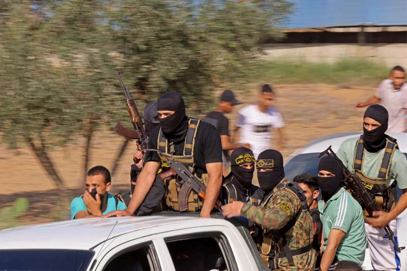 Palestinian militants move toward the border fence with Israel from Khan Yunis in the southern Gaza Strip on October 7, 2023.