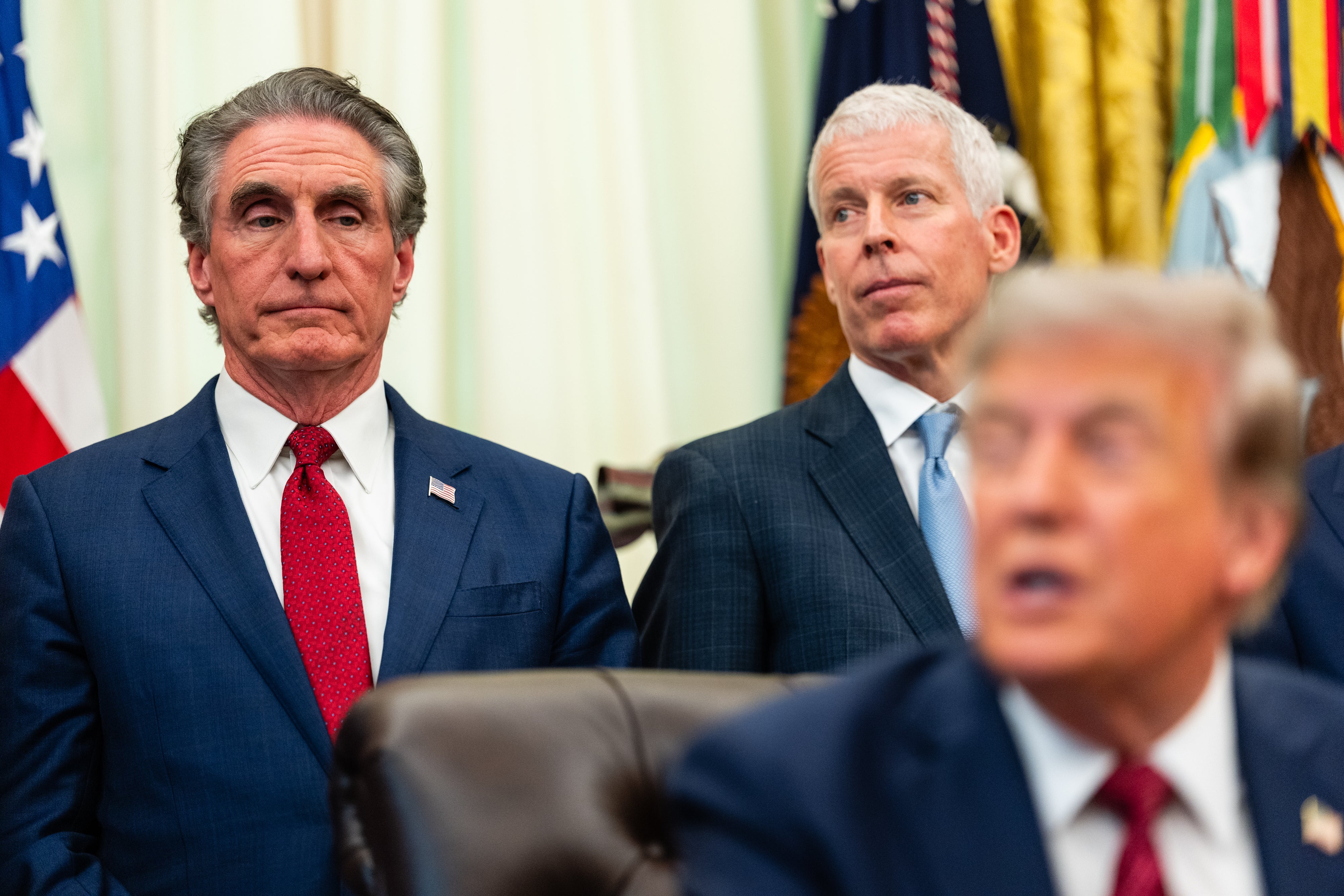U.S. Secretary of the Interior Doug Burgum (L) and U.S. Secretary of Energy Chris Wright (C) listen as U.S. President Donald Trump (R) speaks during an announcement on American nuclear innovation in the Oval Office at the White House in July