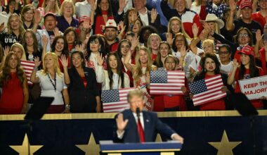 Members of the crowd hold their hands up as they make a pledge with US President Donald Trump during the second day of the Republican National Committee midterm convention. (Patrick T. Fallon / Getty Images)