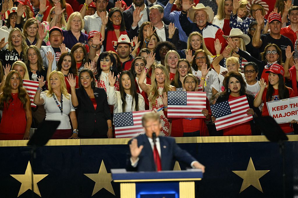 Members of the crowd hold their hands up as they make a pledge with US President Donald Trump during the second day of the Republican National Committee midterm convention. (Patrick T. Fallon / Getty Images)